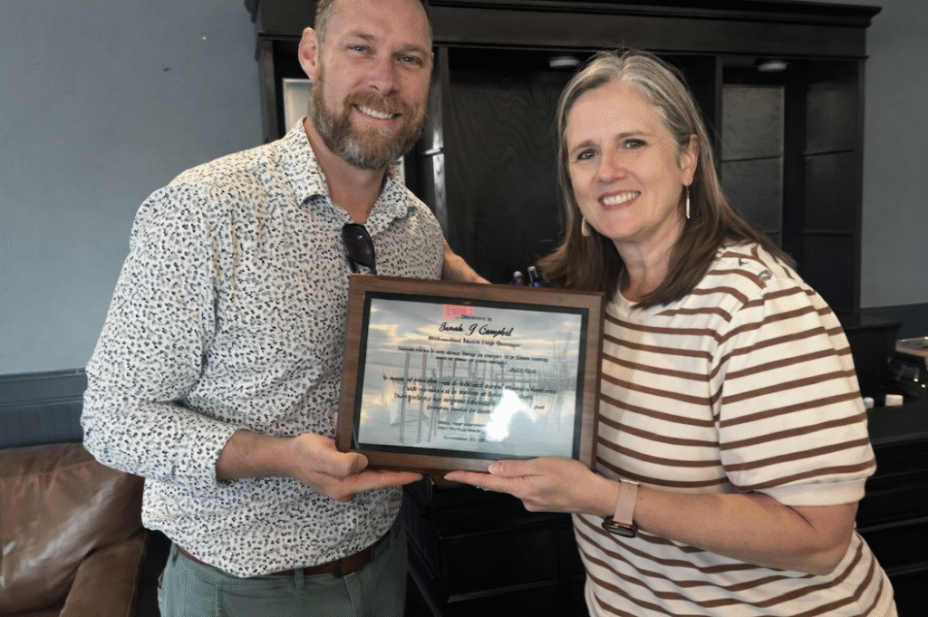 Fernandina Beach City Manager Sarah Campbell receives a commemorative plaque from Deputy City Manager Jeremiah Glission celebrating her first anniversary with the city. Photo courtesy City of Fernandina Beach